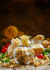 Dry pasta in the shape of three-colored hearts, selective focus