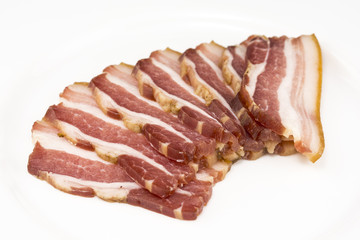 sliced bacon with dill branch on the white background
