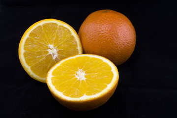 sliced oranges on a black background
