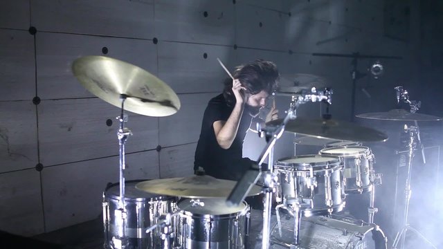 drummer playing drums, in the hangar