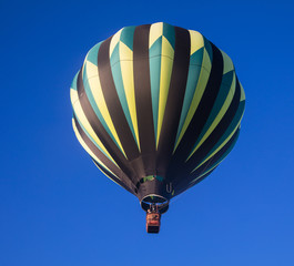 Fototapeta premium Hot air balloon against a deep blue sky just after launch