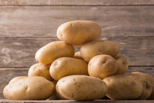 organic potatoes on wooden background