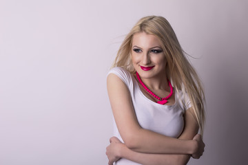 Pretty smiling woman over a grey background