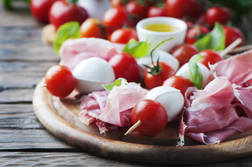 Fresh prosciutto with basil and mozzarella