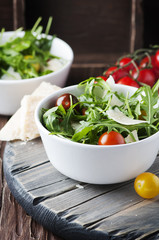 Healthy salad with rocket, tomato and parmesan cheese