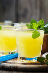 Yellow fresh cocktail with mint and ice