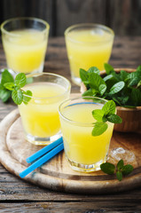Yellow fresh cocktail with mint and ice