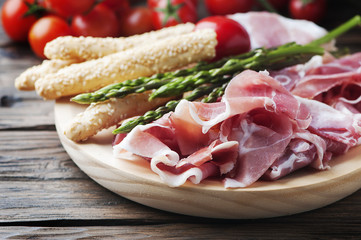 Antipasto with ham and green asparagus