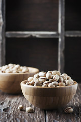Salt pistachio nuts in the wooden bowl