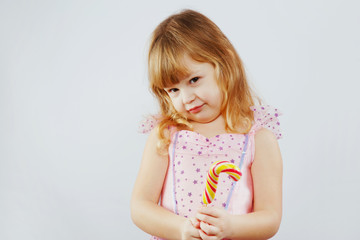 Lovely little girl wearing on pink dress in studio