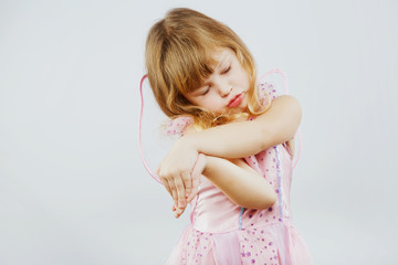 Little cute girl posing on white background in studio