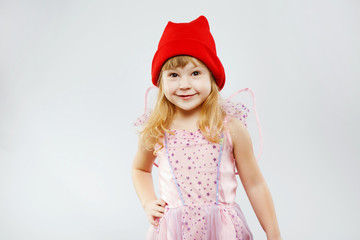 Little smiling girl posing on white background in studio