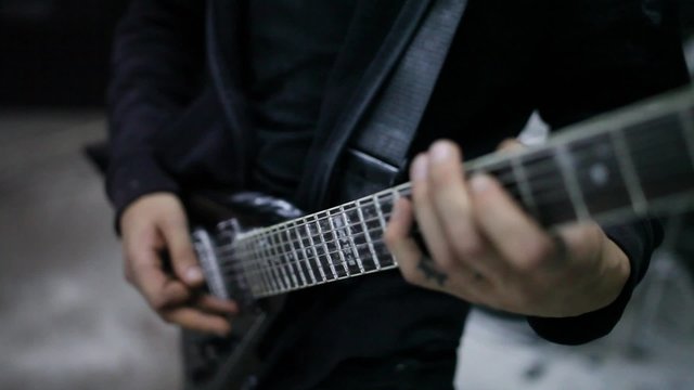 guitarist fingering the strings