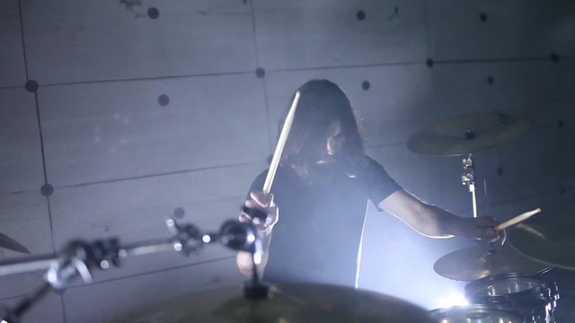 drummer plays the drums in the hangar