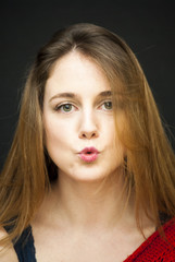 Portrait of Beautiful Young Woman  Giving an Air Kiss