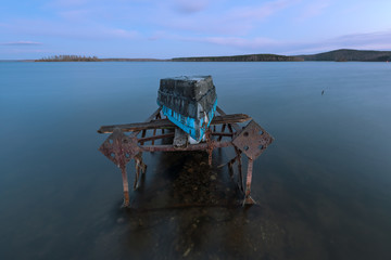 Fototapeta na wymiar old boat on a rusty iron frame