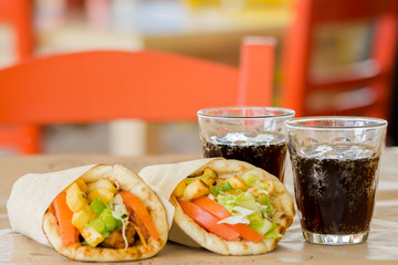 Greek cuisine, souvlaki, gyro pita. and a glass of drink. In the tavern in Greece
