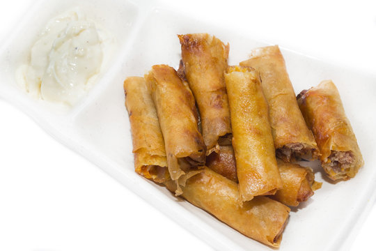 fried rolls with garlic sauce on a white background