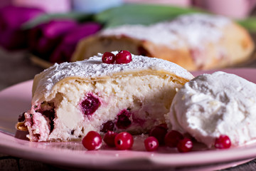 Strudel or pie, tulips and  ice-cream on an old wooden table