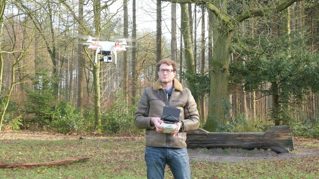 A man is operating a drone, 4K UltraHD, 4K UltraHD