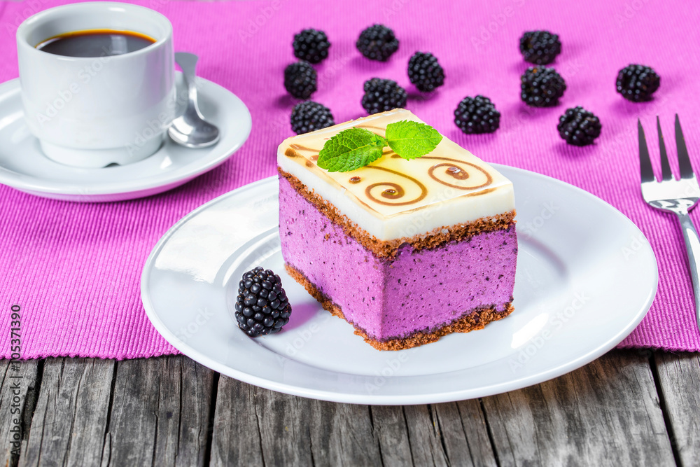 Wall mural piece of cake souffle with blackberries, cup of coffee, closeup