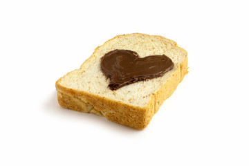 slice bread with heart shape of chocolate hazelnut spread side view, isolated on white background.