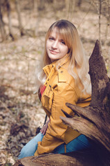 Portrait of smiling blond hair girl in spring forest
