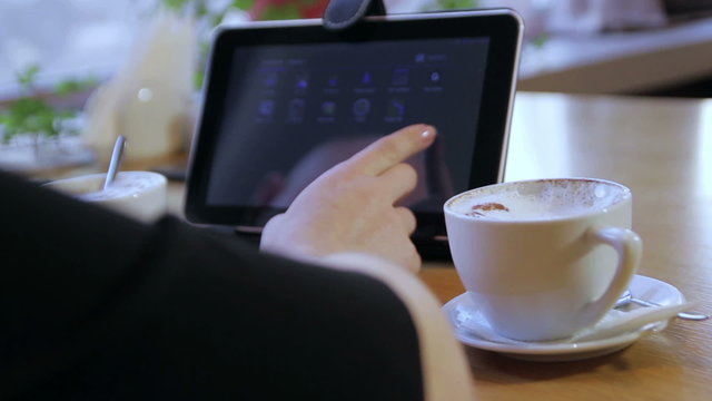 Businesswoman with smartphone drinking coffee in cafe