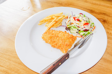 chicken chop, French fries and vegetables salad
