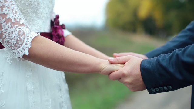 Bride and Groom holding hands on their wedding day.
