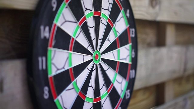 Dart arrow fails to hit the board, unsuccessful attempt. Person losing, failing
