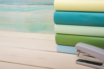 Back to school. Stack of colorful books on wooden table. Copy space