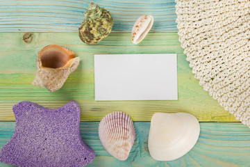 Summer sea vacation mockup background. Notebook blank page with Travel items on blue green wooden table. Sea shells, pebbles, top view.