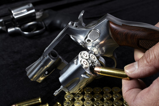Man loading compact magnum revolver firearm