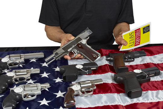 Man with guns For Sale with Safety Brochure on American USA Flag