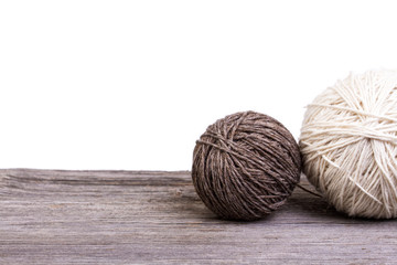 balls of wool on wooden table