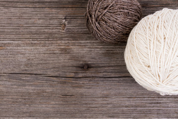 balls of wool on wooden table - top view