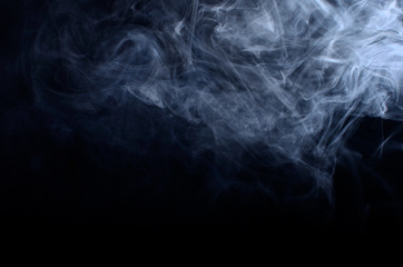 Fluffy Puffs of Smoke and Fog on Black Background