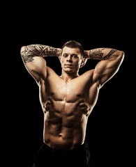 Fototapeta premium bodybuilder posing. Beautiful sporty guy male power. Fitness mus