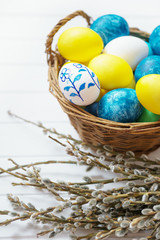 Easter background with colored eggs and catkins