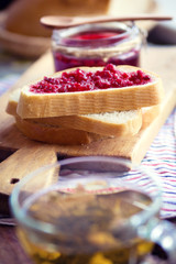 Raspberry jam with bread and tea