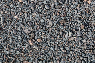 A background of gray, crushed gravel stones as seen from above.  