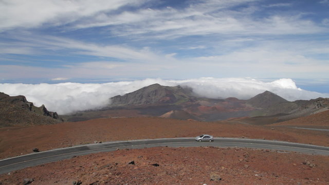 Haleakala Crater Road with a view into Haleakala Crater. At the end of the pan, the upper Visitor's Center and parking lot can be seen in the distance.