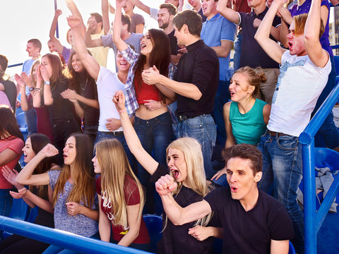 Sport Fans Clapping And Singing On Tribunes. Group People Of Sport Fans.