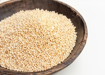 quinoa puffed in rustic wooden bowl isolated white background