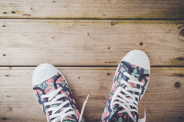 Colorful sneakers on wooden floor