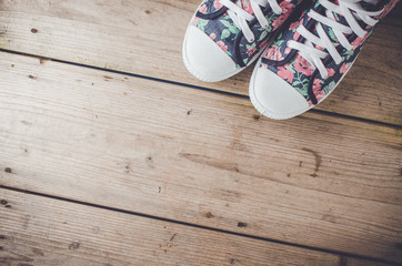Colorful sneakers on wooden floor