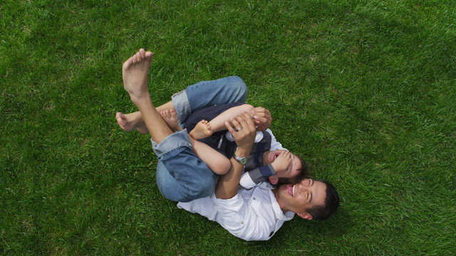 Father and son playing together in grass