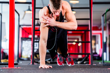 Man doing push-up in sport fitness gym