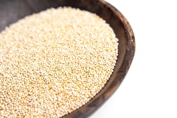 Amaranth puffed in rustic wooden bowl isolated white background